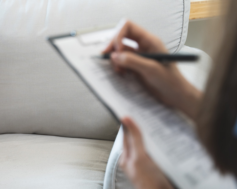 Psychiatric Nurse Practitioner holding a clipboard while doing a psychiatric evaluation in Fargo, ND